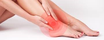 A person holding a painful ankle