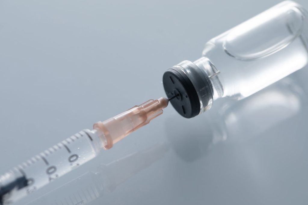 Closeup shot of a vial and needle.