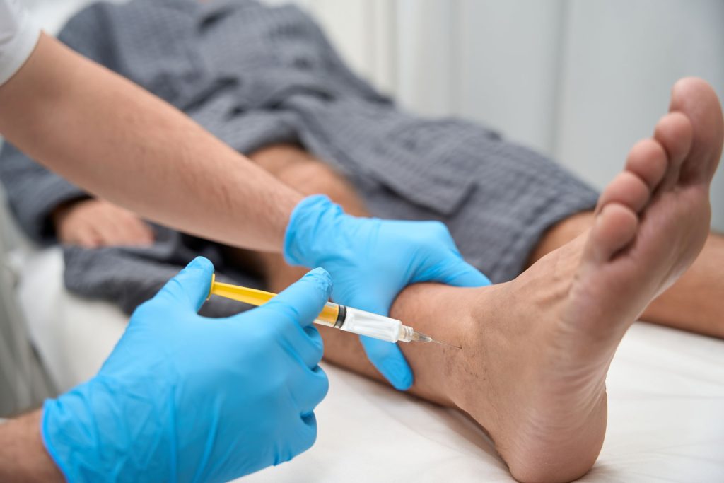 Doctor doing amniotic injection to his patient.