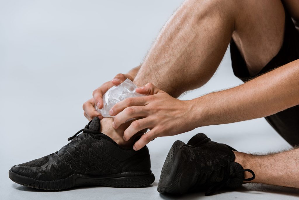Man using ice pack in his feet.