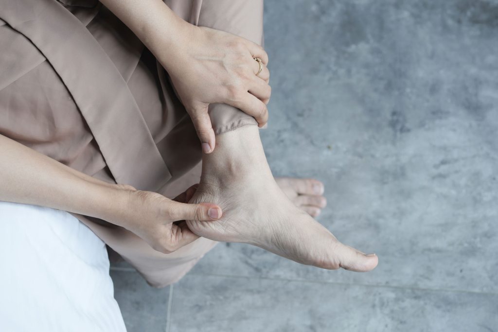 Woman massaging her heel.