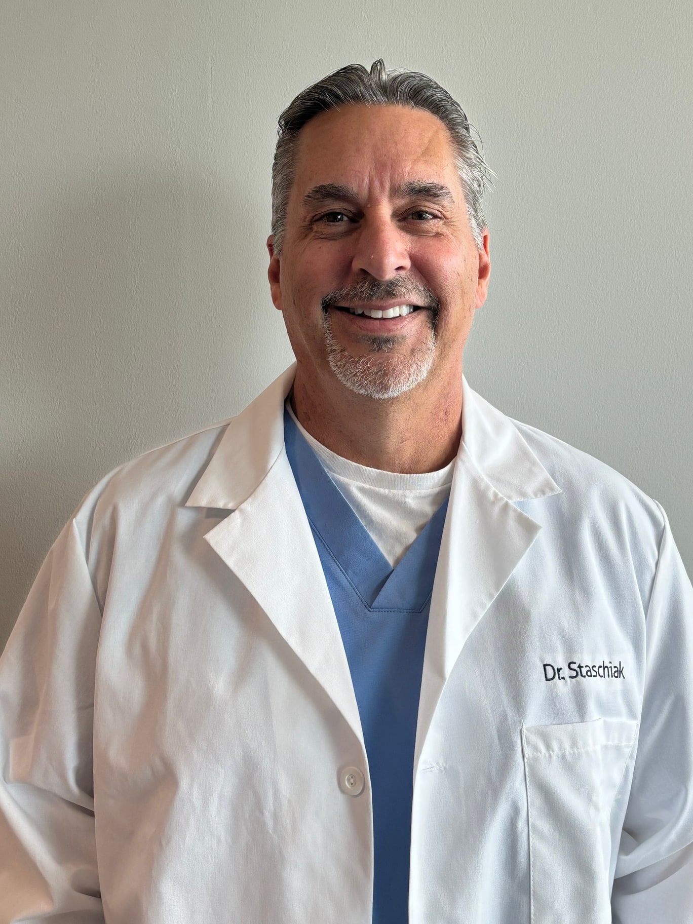 Dr. Vincent J. Staschiak wearing a white medical coat