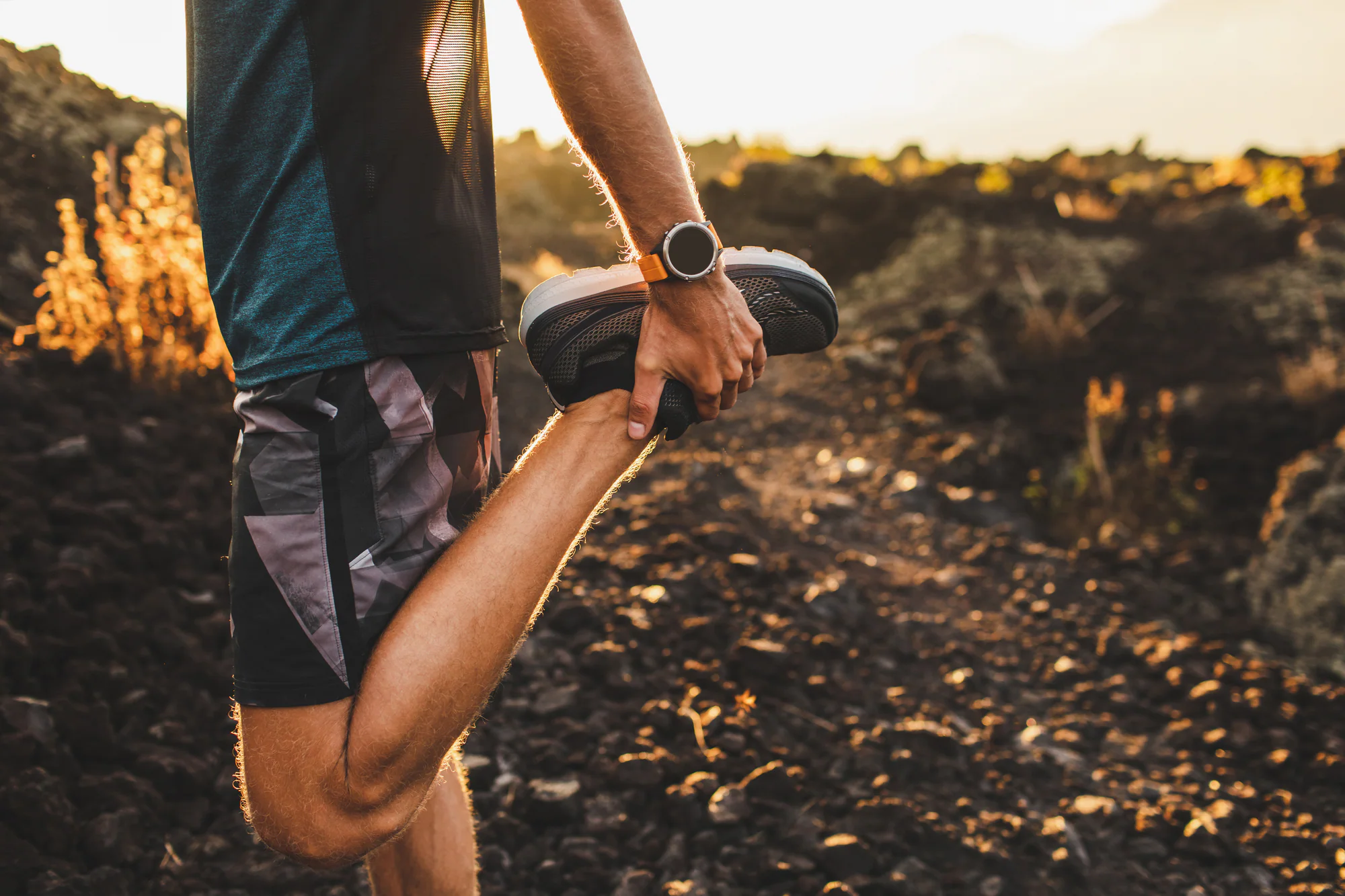 Runner stretching his leg and Achilles tendon outdoors